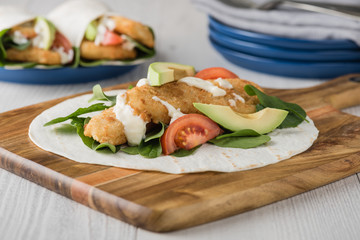 Fish finger wraps with avocado and tomato