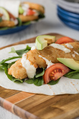 Fish finger wraps with avocado and tomato