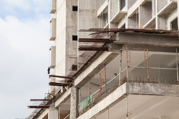 Naklejka premium The technology or art of high rise apartment construction using crane, lift, metal beam, brick, metal ladder and concrete in construction site.