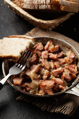 Pieces of sausage fried with onions