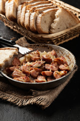 Pieces of sausage fried with onions