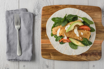 Fish finger wraps with avocado and tomato