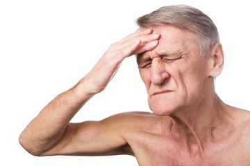 Closeup headshot senior man suffering from headache hands on head   isolated on white background.