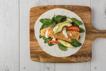 Fish finger wraps with avocado and tomato