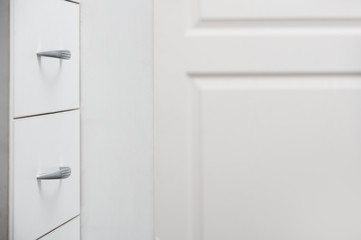 Cabinet with sliding trays and chrome handles