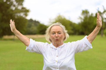 Calm woman in white clothing exercising outside