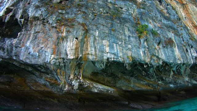 Video 1080p - Massive limestone seacliff, streaked by years of runoff, deeply undercut by erosion from the continuous action of waves.