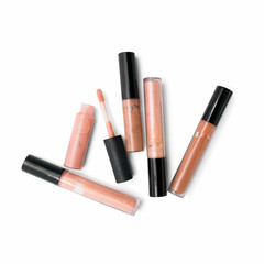 Lip gloss in nude tone from top view isolated on white background 
