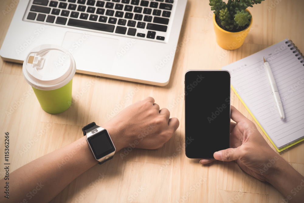 Aufkleber man hand in watch against the background of computer and phone