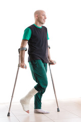 Young man with a leg cast and crutches
