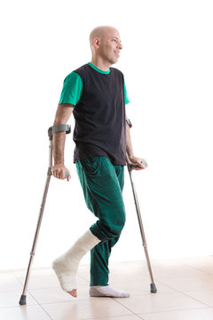 Young Man With A Leg Cast And Crutches