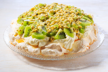 Meringue Pavlova  with whipped cream and fresh fruit.