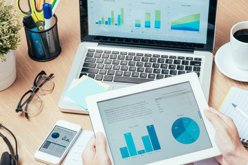 Close-up of businessman looking at business document in touchpad