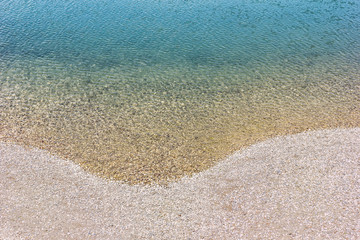 Beautiful turquoise water and pebble beach