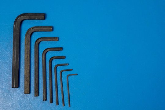 Hex key wrench set on blue table .