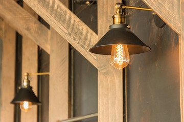 old-fashion lamp hanging on wooden wall