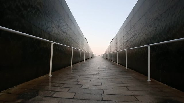 lighted walkway with a fountain on each side