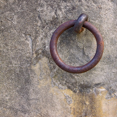 Old iron ring fixed in a plaster wall 