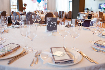 Wedding restaurant table with glasses, napkins and cutlery