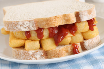 Chip butty potato chips or fries in a sandwich with tomato ketchup