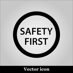 Black round safety first icon on grey background