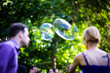 young couple having fun with soap bubbles