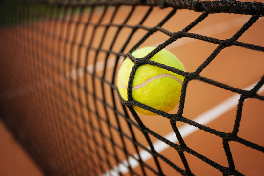 Tennis ball in the net
