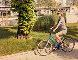 Beautiful woman portrait riding bike in the park