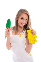 Beautiful young brunette girl in jeans shorts with tools isolated on white background. Beautiful young woman posing in the studio.