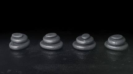 spa concept of pyramid zen basalt stones with water drops on bla