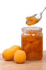 Fresh apricots and jam in a jar