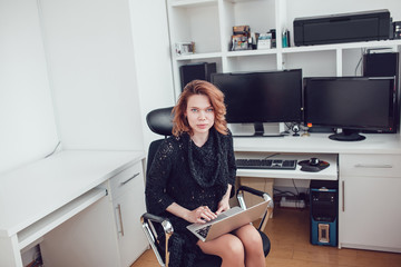 Young business woman with a computer in the office