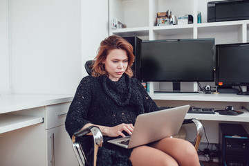 Young business woman with a computer in the office