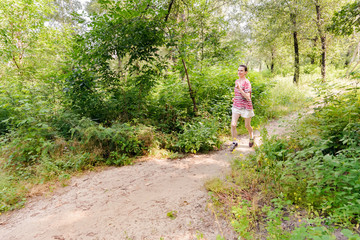 Fototapeta na wymiar Senior Woman Running in the Forest