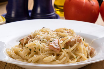 spaghetti carbonara on wooden table
