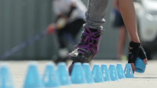 Freestyle skates. Roller skate slalom between cones.
