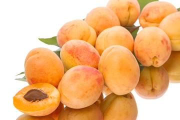 Heap of ripe apricots on a white background