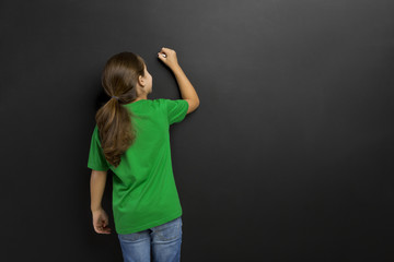 Girl writing in a blackboard