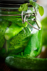 pickled cucumbers with spices in glass jar