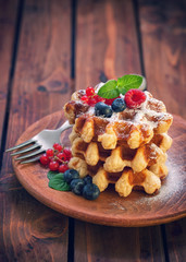 Belgian waffles with raspberries,currant,blueberries and sprinkled with sugar