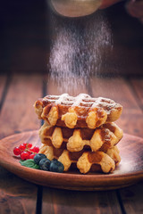 Belgian waffles with raspberries,currant,blueberries and sprinkled with sugar