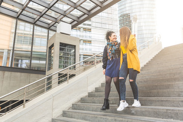 Lesbian couple walking in Potsdamer Platz, Berlin. Two beautiful women on their mid twenties...