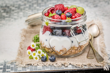 Fresh granola and yogurt decorated with flowers