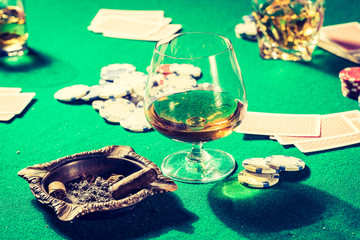 Cards and chips in old gambling table