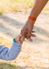 Father and son holding hands, black and white holding hands togeter