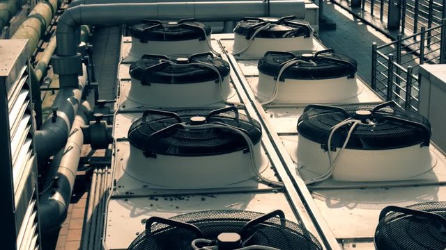A lot of air conditioners on the roof