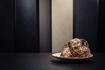 handicraft weaving wicker ball in the wood saucer on the table,