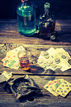 Cards and money on vintage illegal gambling table