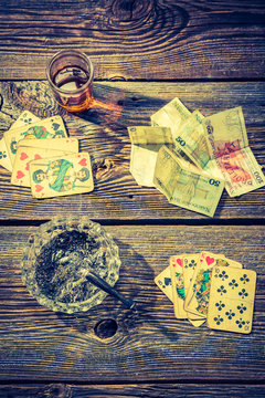 Cards and money on old illegal gambling table