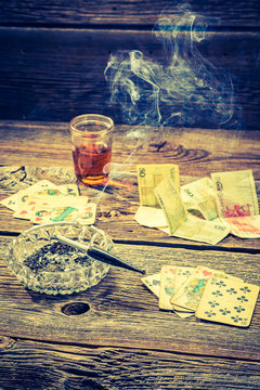 Vintage table for illegal poker with vodka, cigarettes and cards
